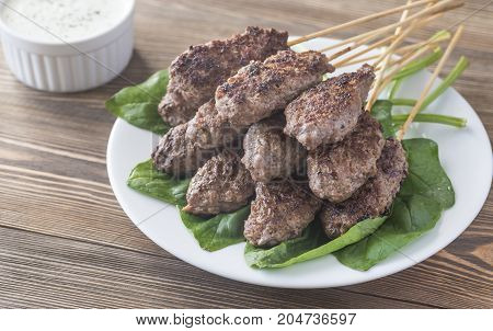 Beef cabobs on the fresh spinach leaves