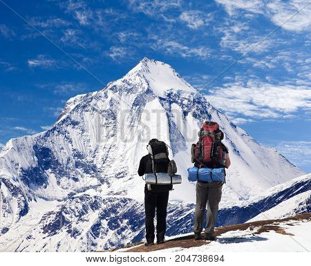 View of mount Dhaulagiri with two tourists great himalayan trail Nepal