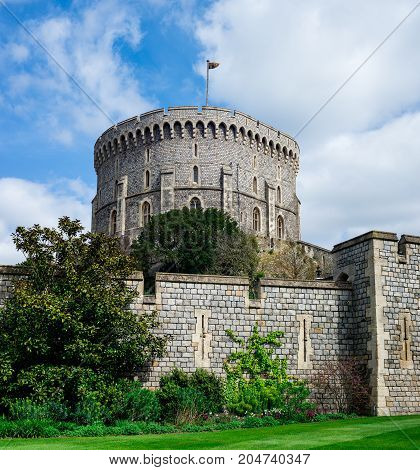 Windsor, England, April 2017: Round Tower with a raised flag in Windsor Castle county of Berkshire England