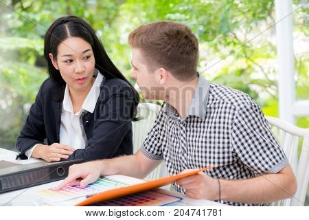 young business people making meeting and looking at document for analyzing marketing working at office on desk.
