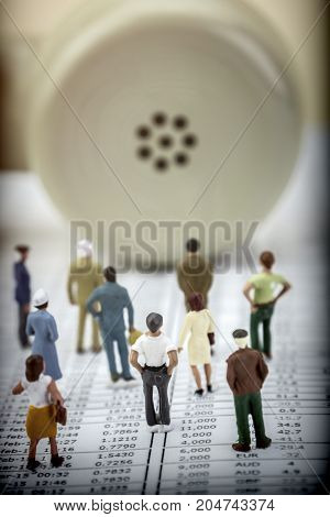 Figures thumbnail against handset old phone isolated on white background, conceptual image