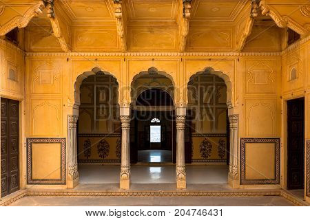 JAIPUR RAJASTHAN INDIA - MARCH 11 2016: Front horizontal picture of yellow painted pillar with beautiful doors of Nahargarh Fort located in Jaipur the pink city of India