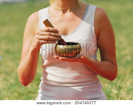 Close-up image of body parts girl's meditation at the health club outside with personal trainer, learning the correct form.