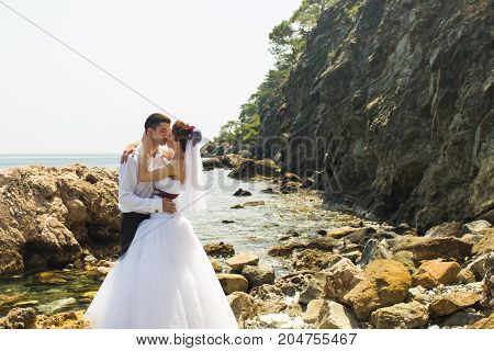 Romantic dating. Young loving couple walking together by the beach enjoying sea.