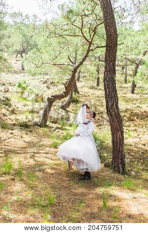 Just married couple embraced on nature. Bride and groom.