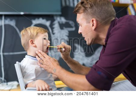 Cute little boy at speech therapist session. Private one on one homeschooling.