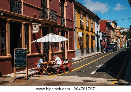 La Laguna Tenerife Canary islands Spain - May 23 2017. People relax and enjoy their drinks and food at outdoor cafe terrace on colorful street of Old Town.