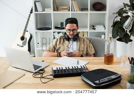 Musician Using Smartphone At Workplace
