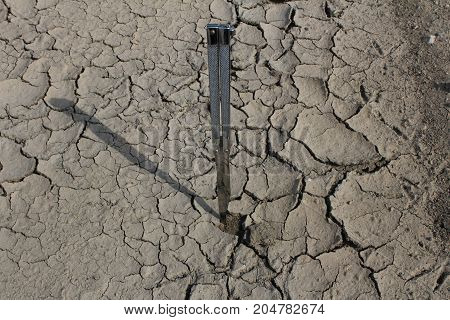 Parched ground and butterfly knife/ This is a detail of parched ground-dry puddle with butterfly knife.