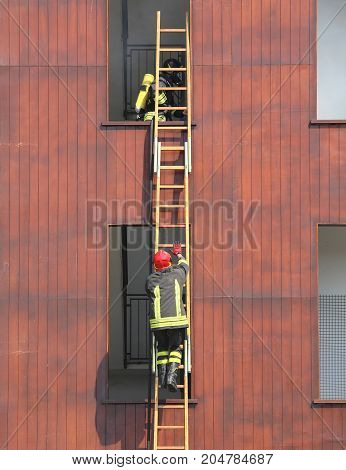 firefighters during a long ladder exercise and the fire brigade building