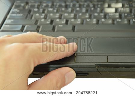 hand pressing SD card put in computer notebook multimedia reader