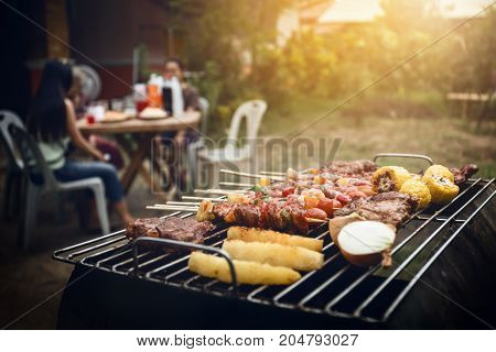 Bbq Grill With Pork And Vegetable On Fire.