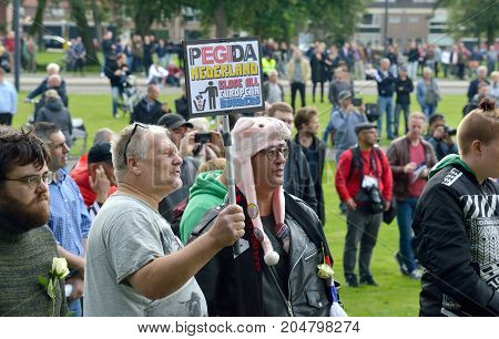 ENSCHEDE THE NETHERLANDS - SEPT 17 2017: People are protesting during an anti islam demonstration of Pegida. Pegida is a group of people who are against the islamization of Europe.