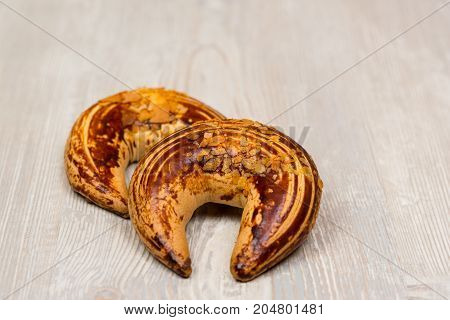 Two chocolate bagels on white wooden table