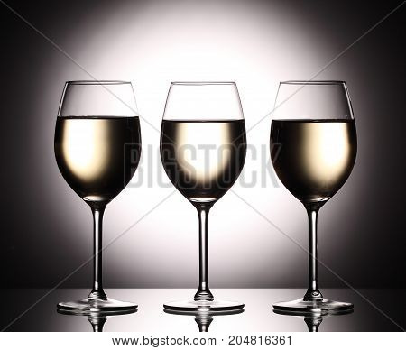 Wineglasses With White Wine - Transperent Liquid - On Studio Background.