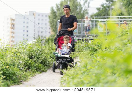 Warsaw, Poland - August 2, 2017: Dad And His Son Spend Time In The City Park.