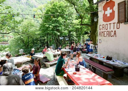 People Eating On A Grotto