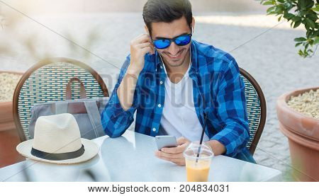 Horizontal Summer Photo Of Handsome European Man In Casual Clothes Spending Afternoon In Outdoor Caf