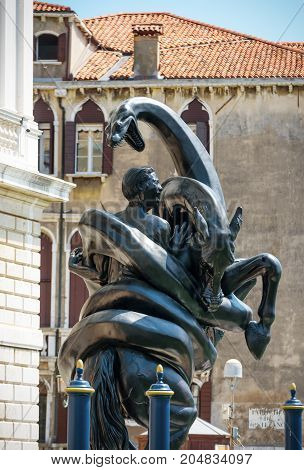 Venice, Italy - May 18, 2017: Sculpture by Damien Hirst outside the Palazzo Grassi next to the Grand Canal. Damien Hirat`s new exhibition opened in Venice in April 2017.