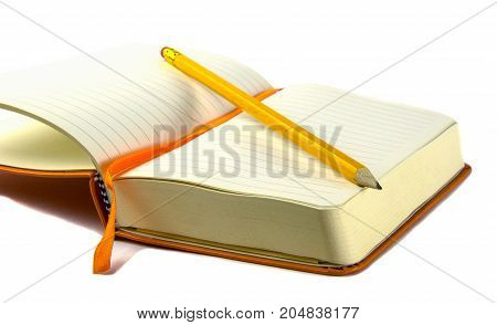Orange notebook with yellow pencil isolated white background