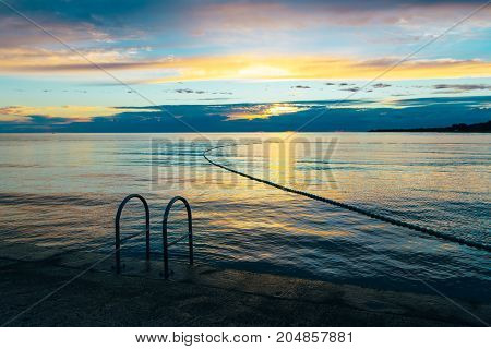 Summer holiday by the sea. Sunset on the seashore. City View Walk along the seafront