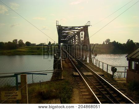 The old bridge over the railway and the inconspicuous reflection of the face on the glass.