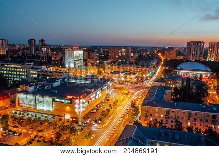 Voronezh, Russia - September 17, 2017: Aerial night view of Voronezh downtown. Kirov street, modern buildings, shops, business center, circus