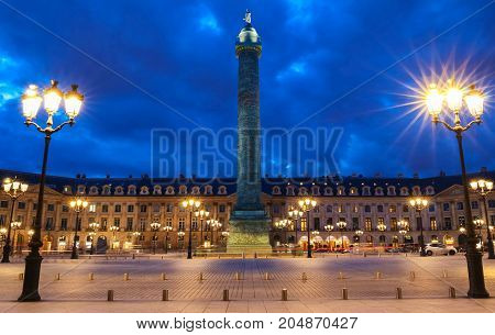 Vendome column with statue of Napoleon Bonaparte, on the Place Vendome at night, in France. Vendome column has 425 spiraling bas-relief bronze plates were made out of cannon.