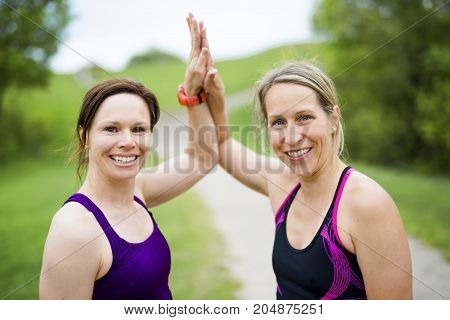Two Beautiful Female runner outside having fun