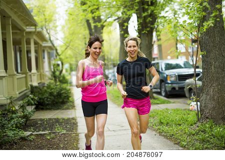 Two Beautiful Female runner outside having fun