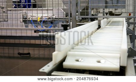 Food factory automated robotic machine. Conveyor product line for cooking and packing rations and food packs. Robotics and automatic lines used instead of human labor on factories and plants.
