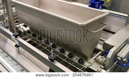 Food factory automated robotic production machine. Conveyor product line for cooking and packing rations and foods. Robotics and automatic lines used instead of human labor on factories and plants.