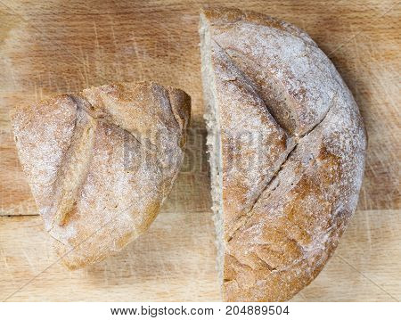 Cut Into Two Halves One Round Freshly Loaf Of Light Color, Baked From Wheat Flour. Photo Close-up, T