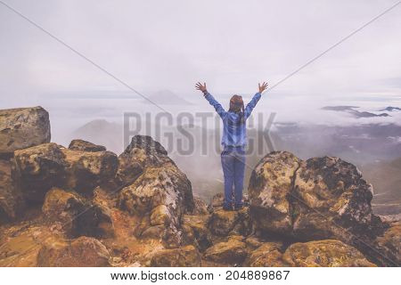 Freedom woman standing on top of Mount Sibayak, Indonesia