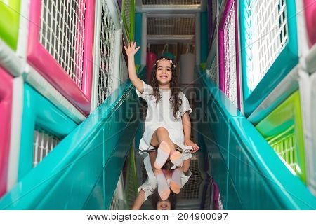 Girl playing on colorful kindergarten playground, having funa