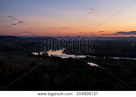 A fabulously beautiful sunset by the countryside reflected in the river in the early autumn.