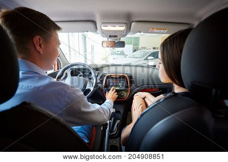 The beautiful couple chose a new car for themselves. The concept of buying a new car.