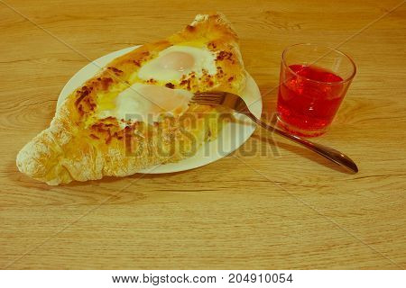 Adjarian khachapuri with eggs on the table. Delicious homemade khachapuri in Adjarian - Retro color