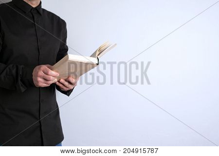 Free space for text, marketing education and business information. Man with a book on white background.