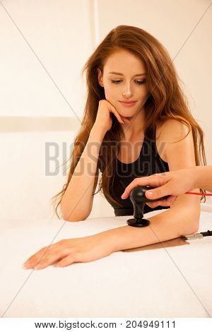 Physiotherapist doing Tecar therapy alterantive treatment on a woman patient