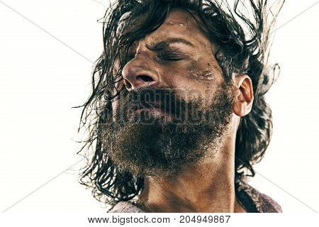 Portrait of a brutal bald-headed viking in a battle isolated against a white background. Early medieval period. Actor in makeup. concept of vagrancy and survival
