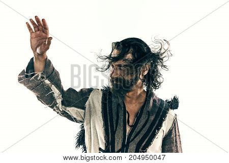 Portrait of a brutal bald-headed viking in a battle isolated against a white background. Early medieval period. Actor in makeup. concept of vagrancy and survival