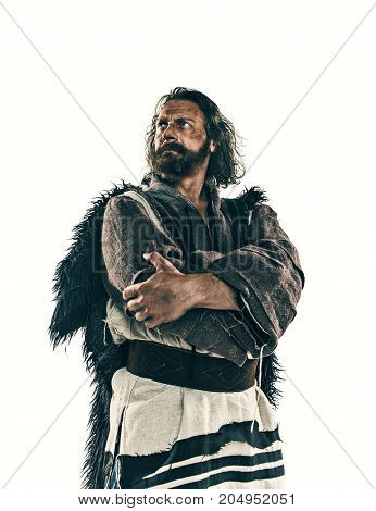 Actor in makeup, a poor man isolated on white studio background. The bum in canvas rags. concept of vagrancy and survival