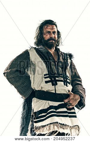 Actor in makeup, a poor man isolated on white studio background. The bum in canvas rags. concept of vagrancy and survival