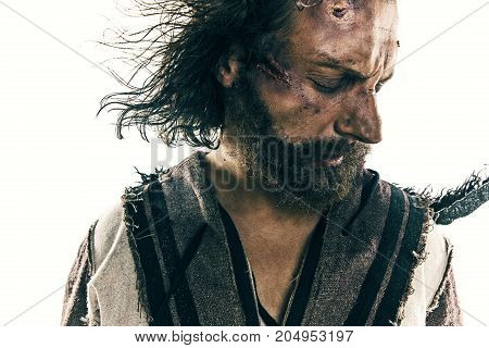 Portrait of a brutal bald-headed viking in a battle isolated against a white background. Early medieval period. Actor in makeup. concept of vagrancy and survival