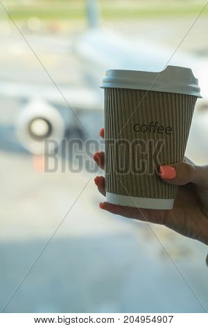 Cup Of Coffee In Airport's Business Lounge With Aircraft