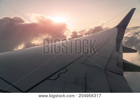 Sun and Clouds and sky as seen through window of an aircraft.