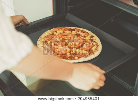 Woman Preparing Homemade Pizza In Hot Oven.