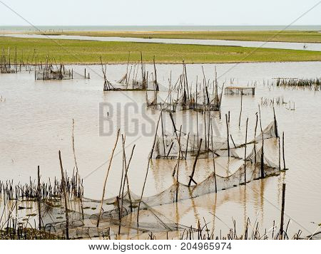 Fishnet or purse net or purse seine for fishing catch in river. Purse net is traditional equipment of Thai fishery. Phatthalung Thailand.