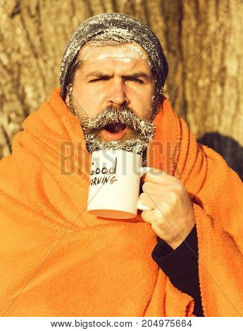 Man In Blanket With Cup